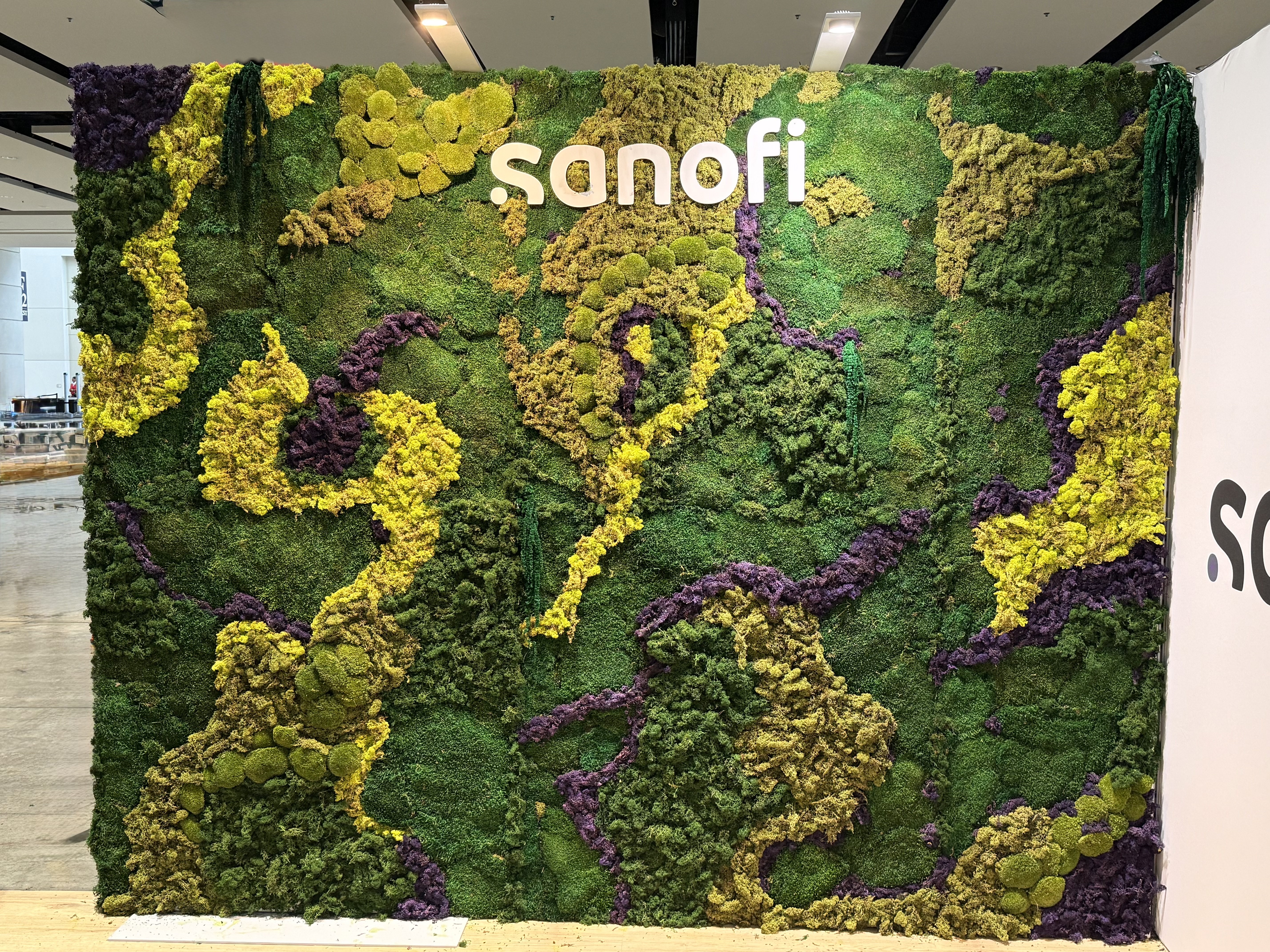 A Preserved Moss wall with a Sanofi logo